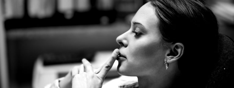 Female salesperson contemplating buyer psychology and sales process.