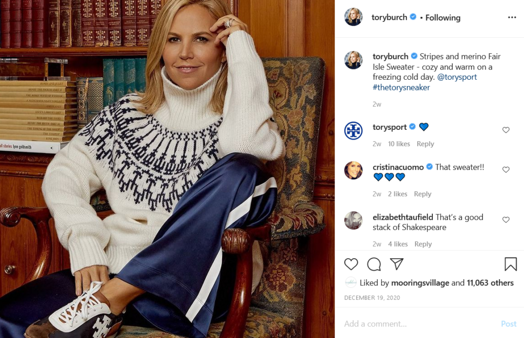 Instagram screenshot of Tory Burch founder sitting on chair at home modeling sweater