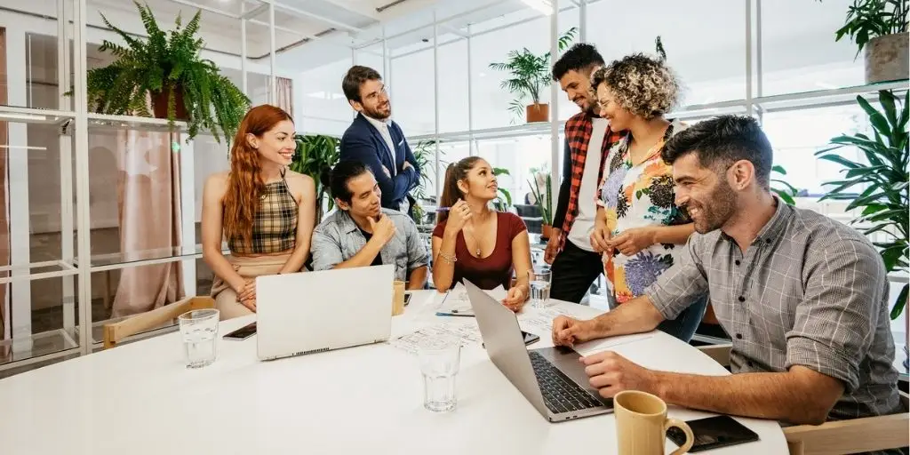 Person holding a mobile phone showing Instagram account with carousel posts.
