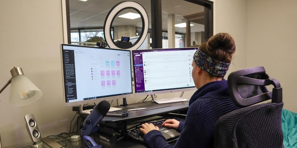 A project manager uses a Gantt chart on her laptop computer for marketing project management.