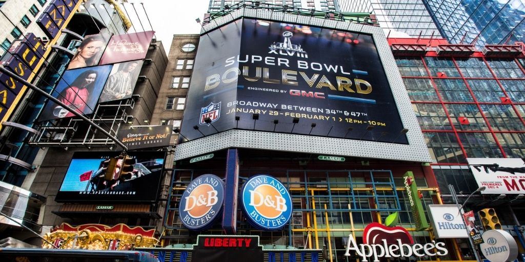  Advertisement prior to the Super Bowl event - NY Times Square featuring a 
billboard with Super Bowl ads.
