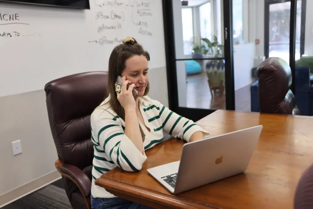 A woman giving her valuable feedback via a survey on her phone, a reminder of the benefits of surveys.