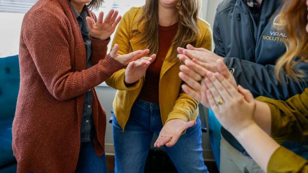 Members of Viral Solutions team smiling and clapping.