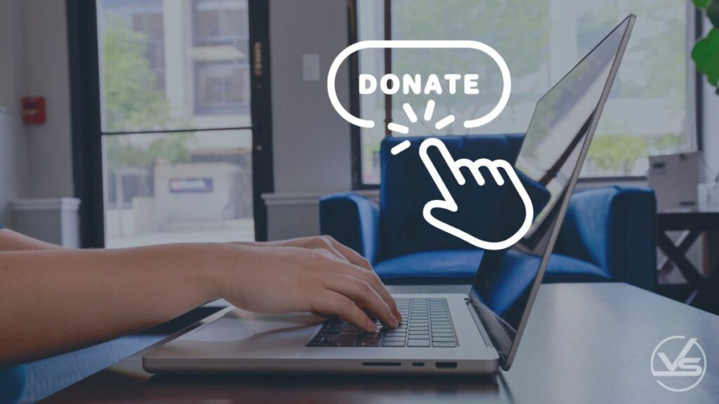 Person sitting at laptop in office with text overlay that reads donate. 