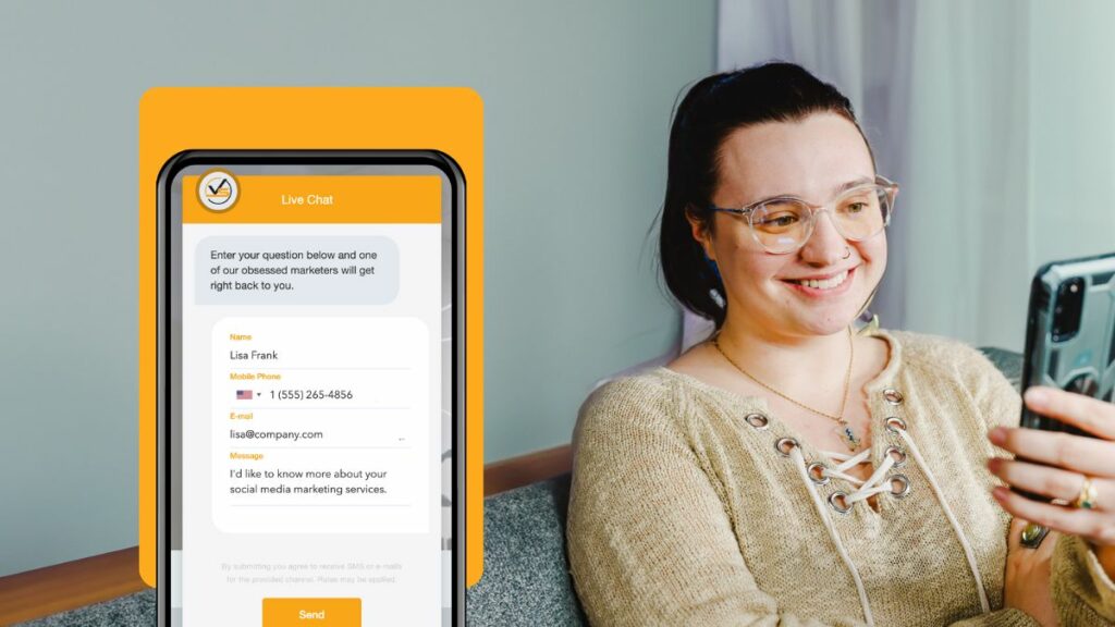 Conversational marketing in action, with Holland of Viral Solutions smiling at phone and screen showing chatbot.